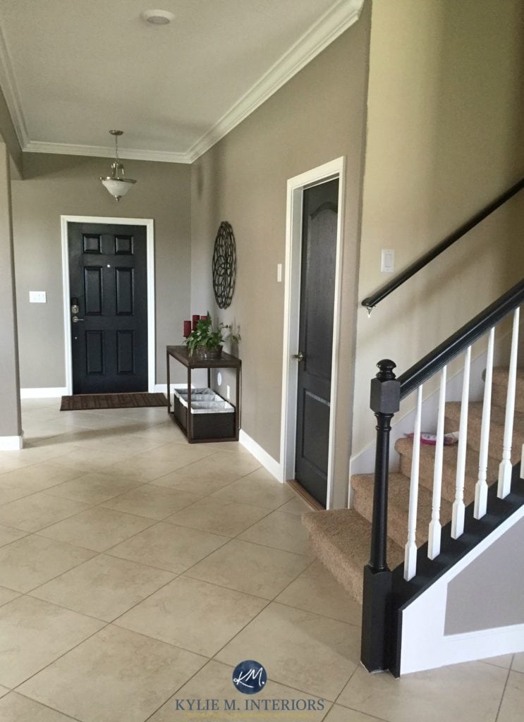 Sherwin Williams Keystone Gray in a low light foyer and hallway with tile flooring and black paint doors and handrail. Kylie M Interiors ONline Colour Consulting and E-design services