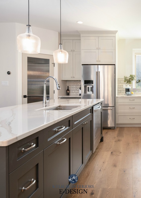Kitchen island painted dark gray green, Brittanica Warm quartz countertop, warm gray cabinets. Kylie M Interiors Edesign, online paint color advice