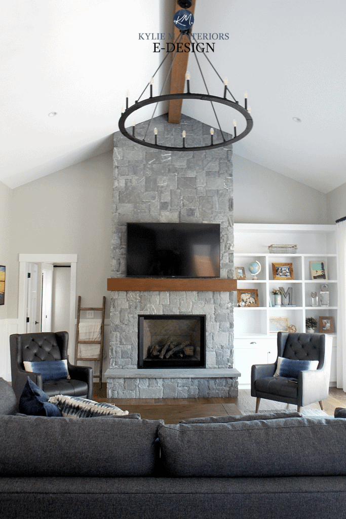 Living room, great room, k2 stone fireplace, vaulted ceiling, wood mantel, tv, gray leather chairs, gray paint color, built cabinet. Kylie M Interiors Edesign, online paint color