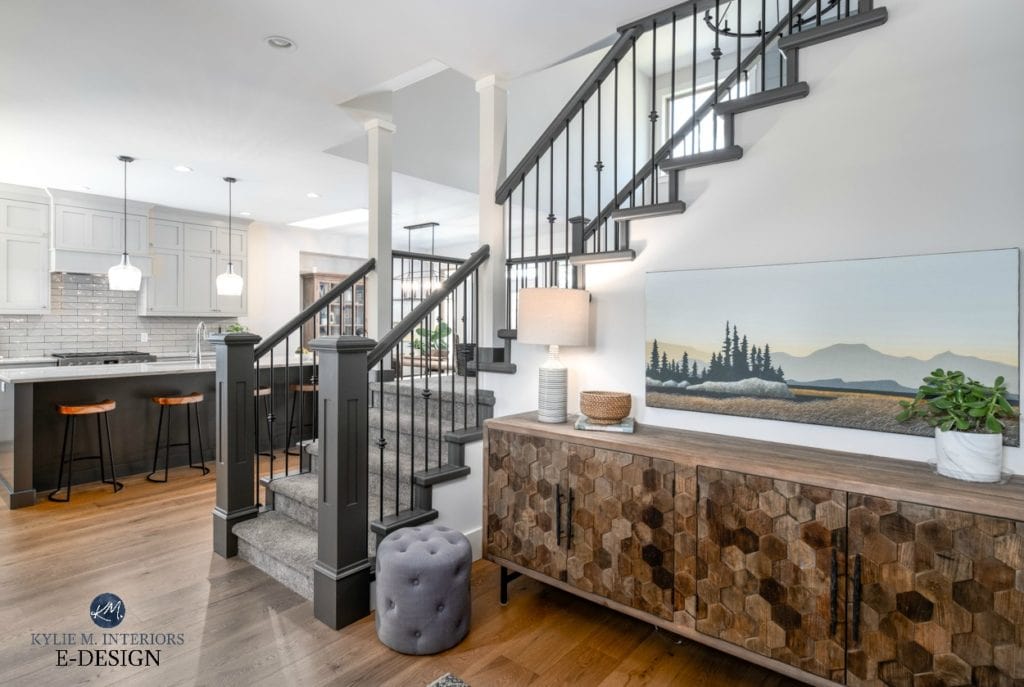 Open layout entryway, kitchen stairwell. warm gray kitchen cabinets, white oak flooring and painted stair railing with carpet. Kylie M Interiors Edesign, online paint colour consulting