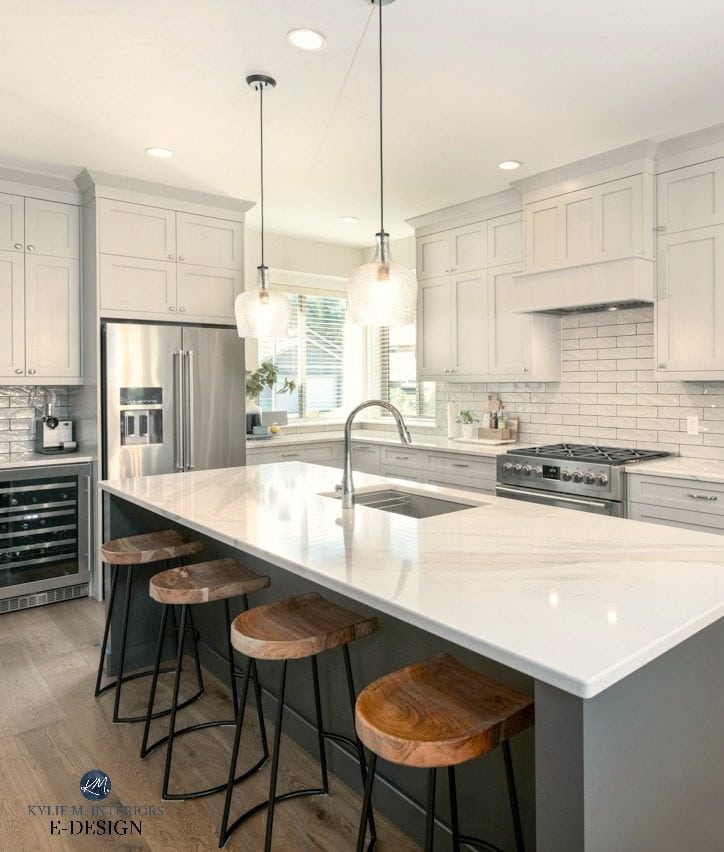 Kitchen island painted a dark gray green with Brittanica Warm quartz countertop, warm gray cabinets and subway tile backsplash. Kylie M Interiors Edesign, online paint color consultant