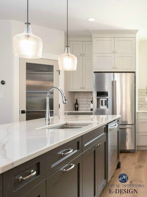 Kitchen with island, white oak flooring, Cambria Brittanica Warm quartz countertop, dark painted island with warm gray cabinets