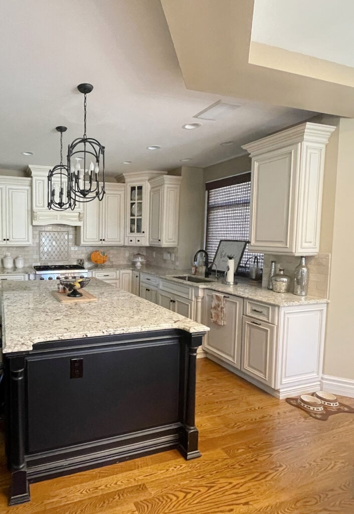 Sherwin Williams Kilim Beige paint color, glazed cream cabinets similar Antique White, wood floor, dark island, similar Giallo granite