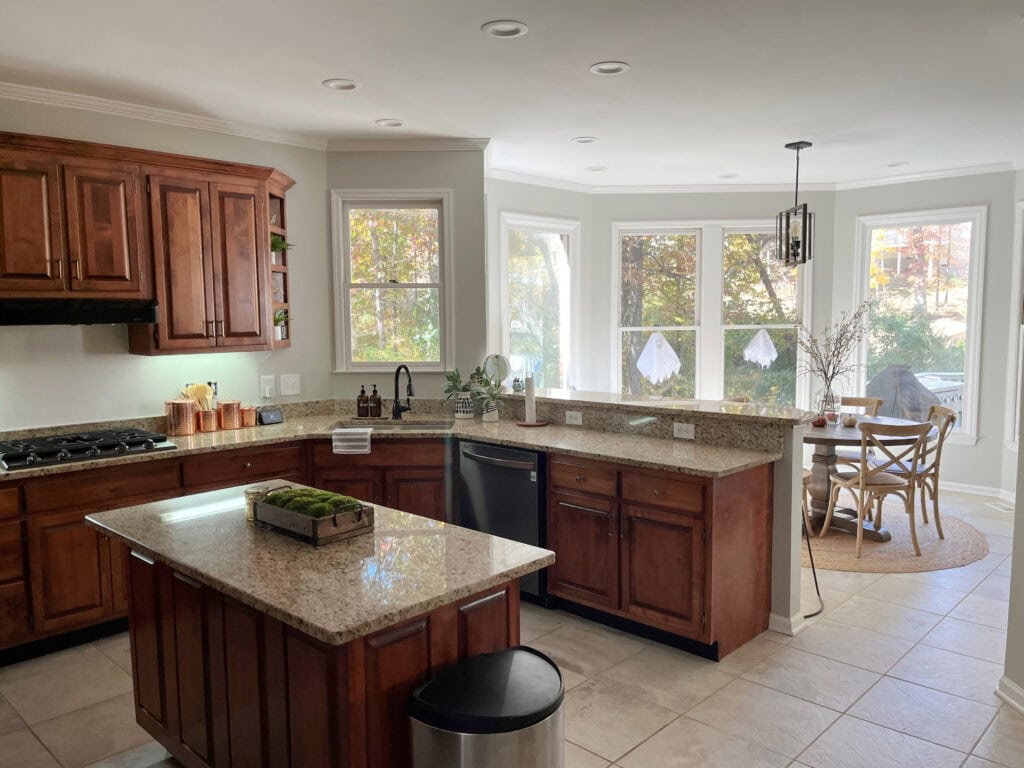 St. Cecelia, similar to Venetian Gold granite countertops, cherry red wood cabinets. Repose Gray on walls, too gray