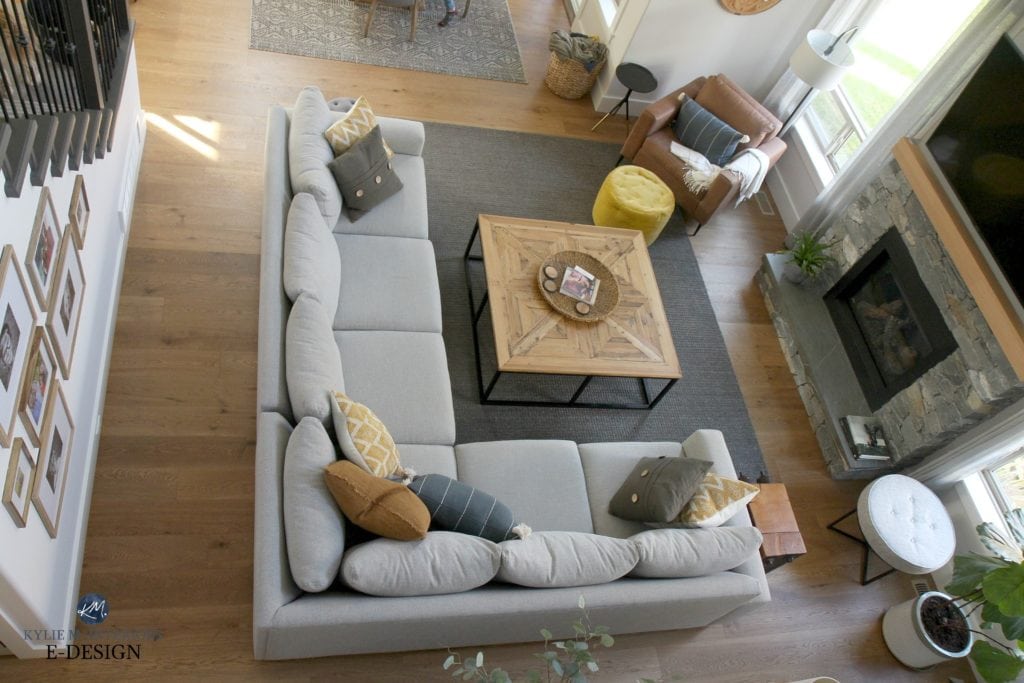 Living room furniture layout, sectional, square wood coffee table, brown leather accent chair, white oak flooring. stone fireplace. Kylie M INteriors Edesign, online paint color