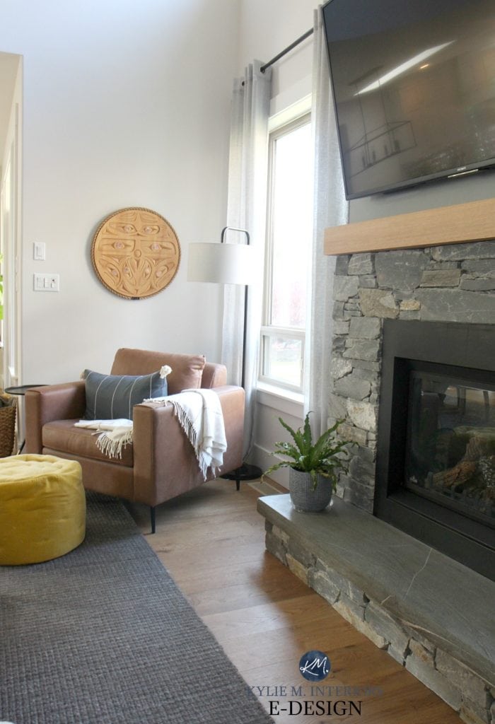 Living room leather accent chair. First nations indigenous carving by Noel Brown. K2 stone fireplace, white oak floor. Kylie M Interiors Edesign, online paint colour expert and DIY decorating tips