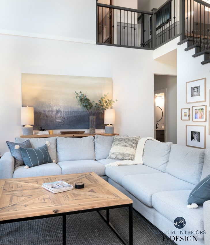 DIY decorating and design ideas. Living room with open stairwell. Large gray sectional, rustic wood coffee table and sofa table, home decor, off-white greige paint color. Kylie M INteriors Edesign, online paint color consulting