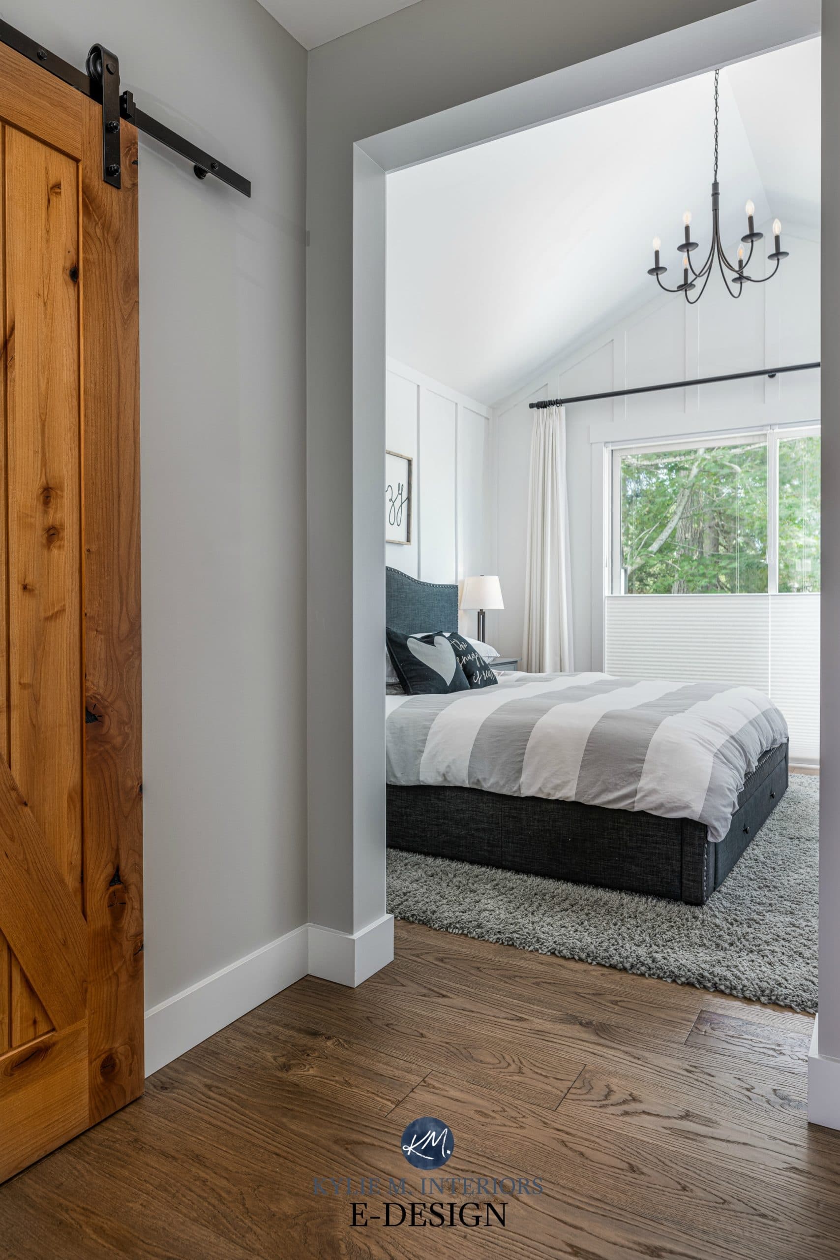 Master Bedroom, white board and batten paint colour, vaulted ceiling, chandelier, wood barn door and white oak flooring. Stonington Gray. Kylie M Interiors Edesign, online paint color advice blog