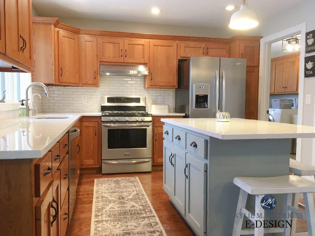 Oak kitchen with wood cabinets, painted island, update ideas white quartz countertop and subway tile backsplash. Kylie M Interiors DIY paint color advice blogger