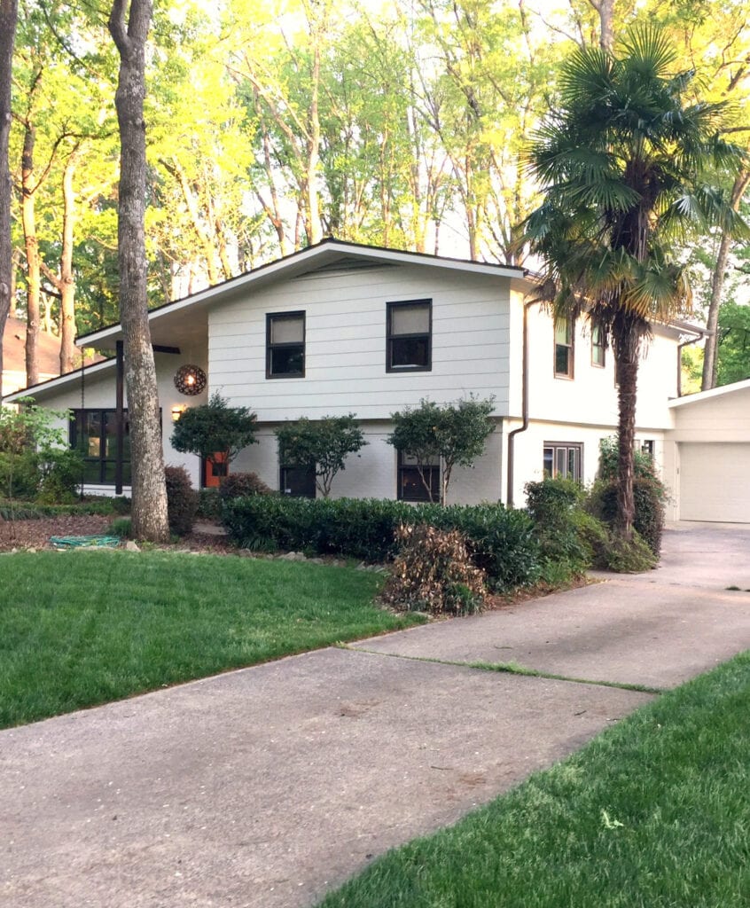 Exterior split level, painted brick and siding. Cream, brown and orange palette. Kylie M Interiors E-design. Subtle mid-century style