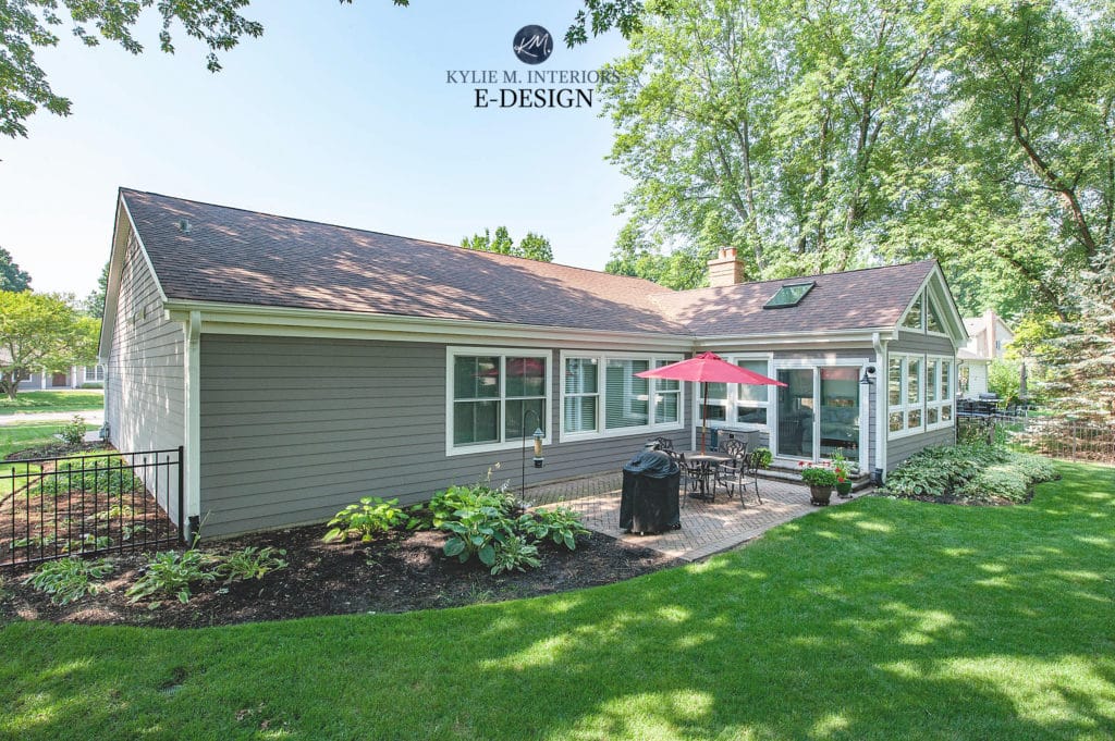 Exterior north facing back of home with gray siding and brick. Kylie M Interiors edesign