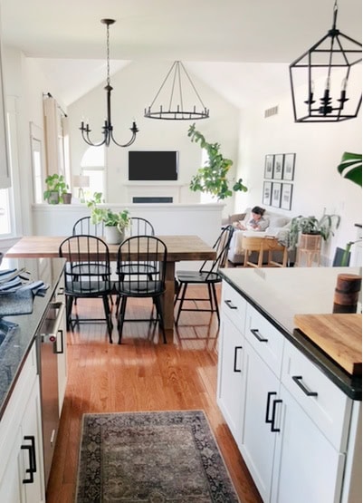 Kitchen, living room, dining room - open layout, Sherwin Williams Alabaster, red oak floor, warm white paint colour, painted cabinets. Kylie M edesign