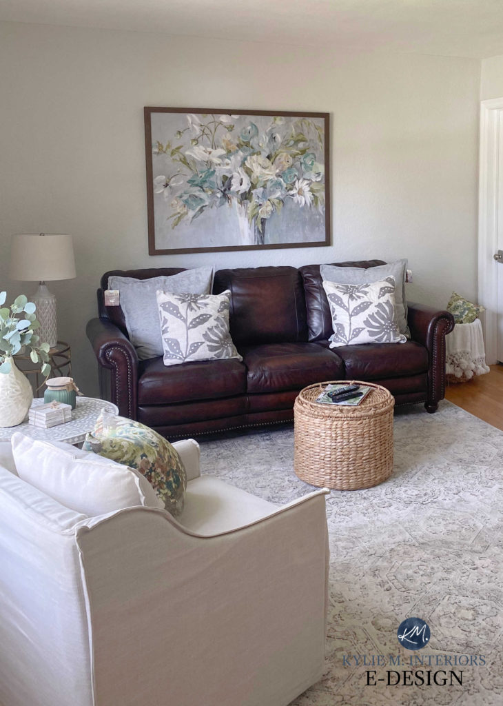 Living room with leather sofa, transitional style home decor. Sherwin Williams Egret White on walls, warm neutral paint colour. Kylie M Interiors Edesign, online paint colour consultant