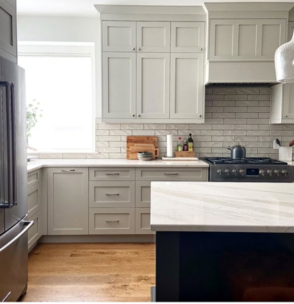 Revere Pewter kitchen cabinets, Cambria Brittanica warm quartz, URbane Bronze island, oak wood floor. Kylie M Interiors Edesign