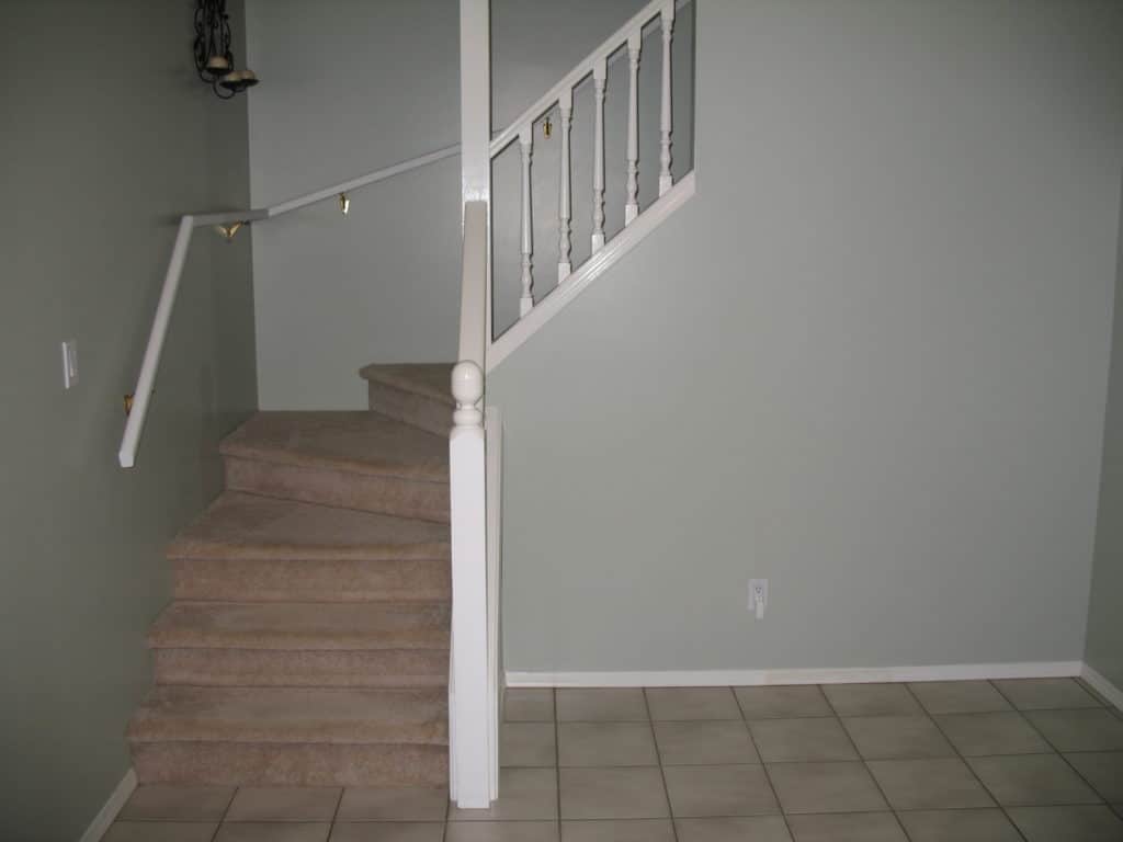 1990s home with carpet and tile with pink undertone 