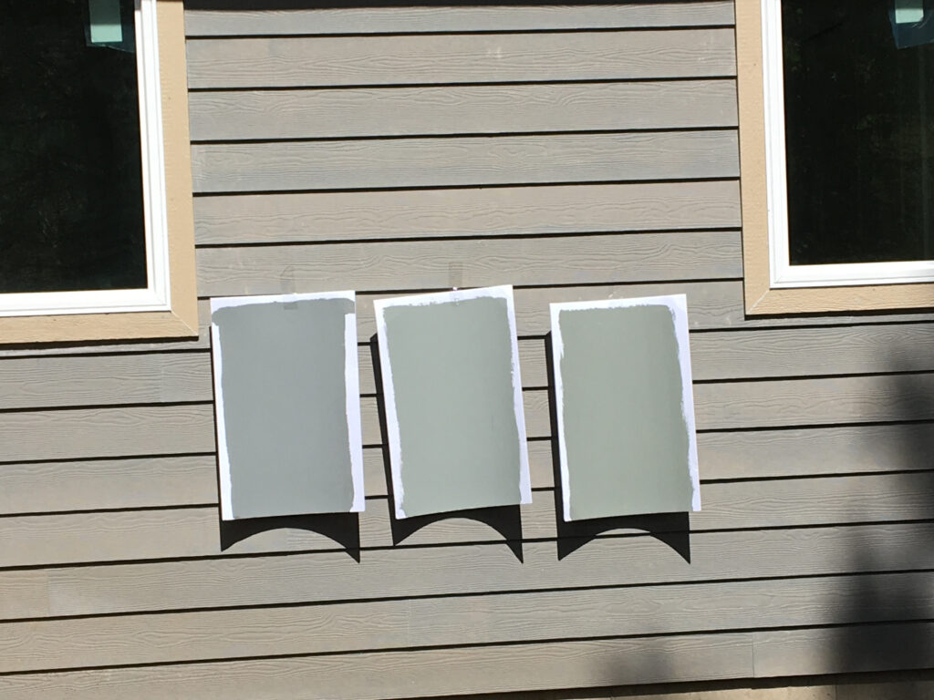 Sherwin Williams Cityscape, Illusive Green and Attitude Gray paint samples on exterior siding