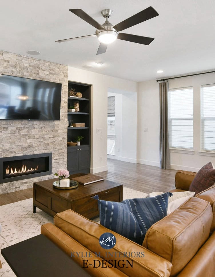 Living room, stacked stone fireplace, tv, builtins painted Benjamin Cheating Heart, Pure White walls,cognac leather. Kylie M Interiors Edesign, online paint color consultant (4)