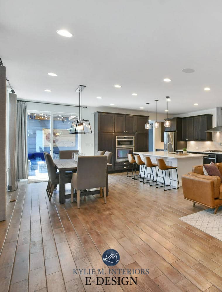 Open concept layout living, dining room and kitchen, wood tile look floor, cognac leather, Sherwin Pure White walls, dark wood cabinets. Kylie M Interiors Edesign