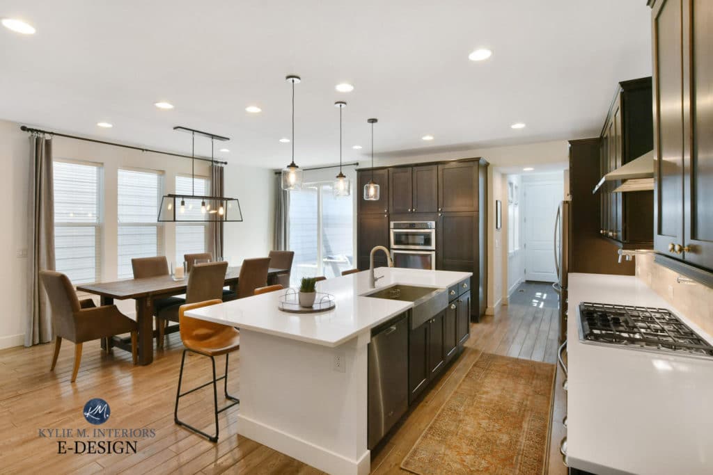 Open layout dining room, kitchen dark wood cabinets, tile wood look floor. Sherwin Williams Pure White. Paint color consulting Kylie M Interiors Edesign