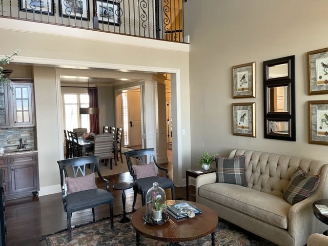 Benjamin Moore Lenox Tan formal traditional style living room, Irish Cream trim, dark wood floor and furniture. Best beige color