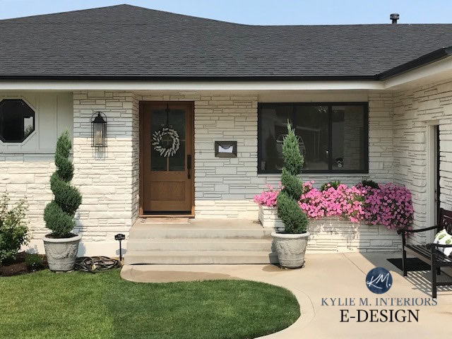 Exterior 1960 stone painted cream off white paint colour, wood look garage door, dark gray black roof. Kylie M Interiors Edesign, online paint color consulting and diy decorating advice (2)