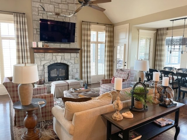 Formail traditional family room living room, warm cream beige stone fireplace, Benjamin Moore Lenox Tan walls, wood floor, tv above fireplace mantel, vaulted ceiling
