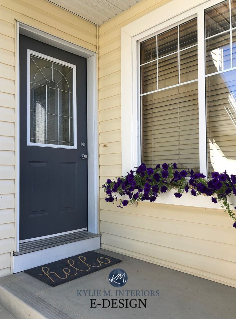 Front door painted Sherwin Williams Cyberspace, navy blue with yellow siding. Kylie M INteriors Edesign