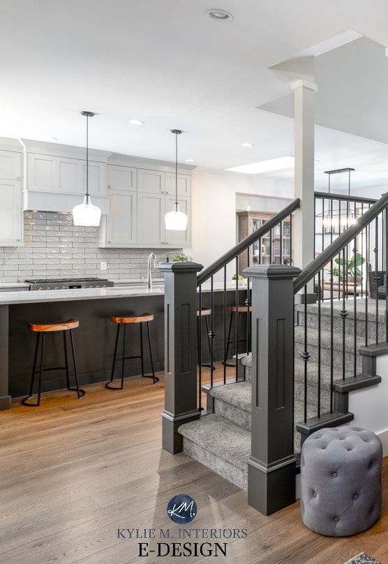 Kitchen cabinets, Benjamin Moore Revere Pewter, Sherwin Urbane Bronze island, stair railing, gray carpet, white oak. Kylie M Interiors Edesign.
