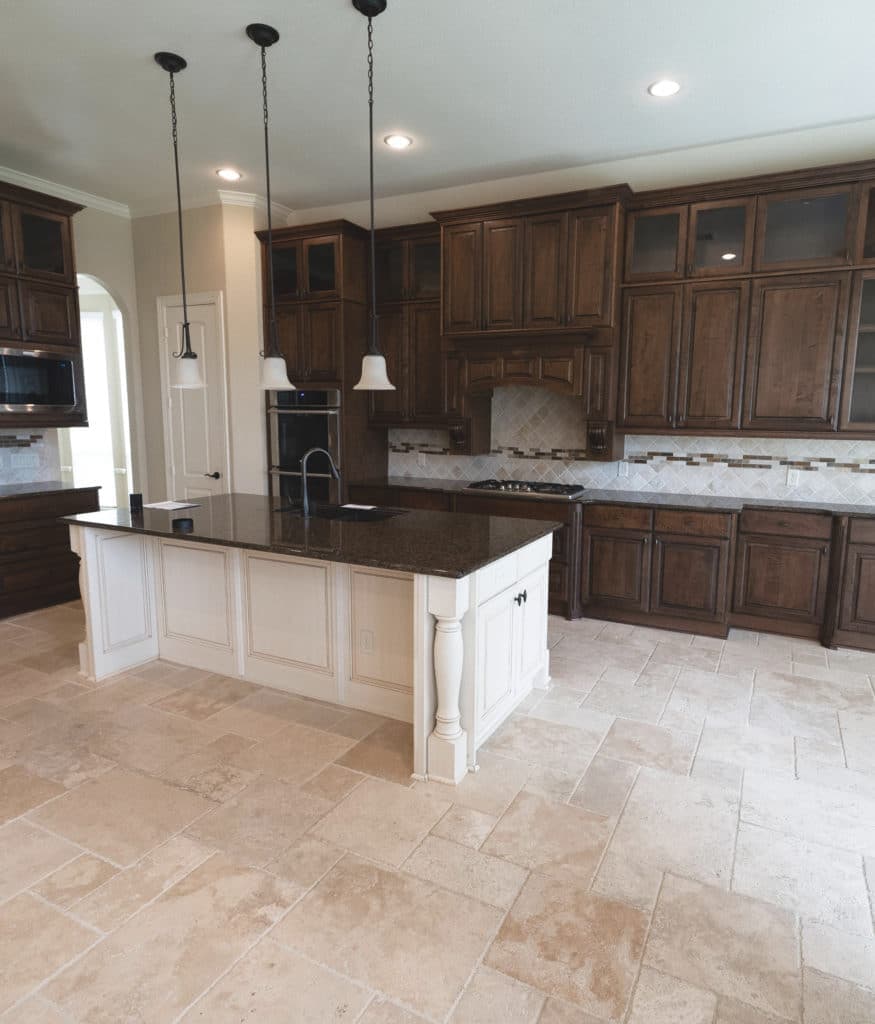 Travertine tile floor, black granite countertop, cream painted island, dark wood cabinets. Kylie M interiors edesign, client before photo