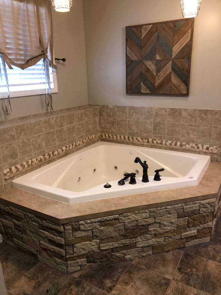 bathroom with beige tiles and stone before edesign update