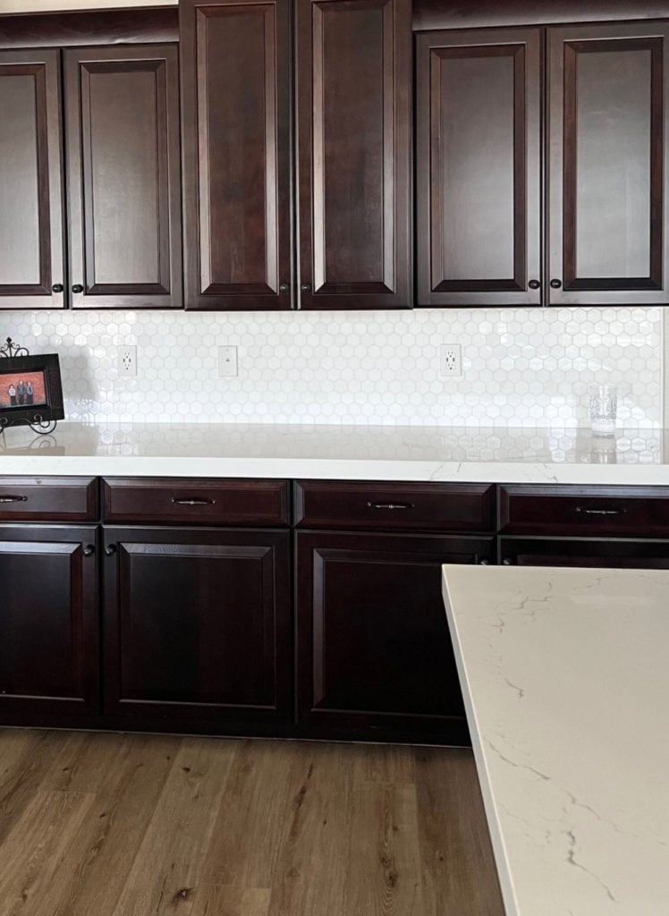 Edgecomb Gray paint colour on walls, dark cherry red stain wood cabinets, hexagon tile backsplash, Inverness Frost Cambria white quartz countertop. Kylie M Edesign (1)