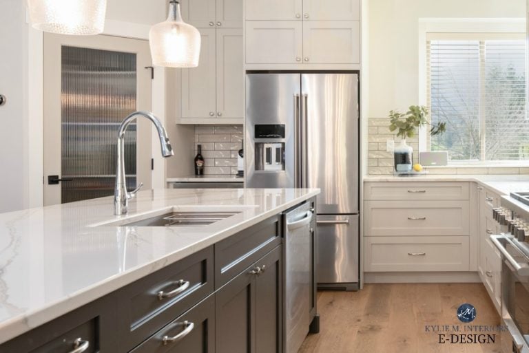 Kitchen with white Warm Brittanica quartz countertop, dark gray green painted island, warm gray cabinets. White oak flooring. Kylie M Interiors, E-design, online paint colour consulting blog