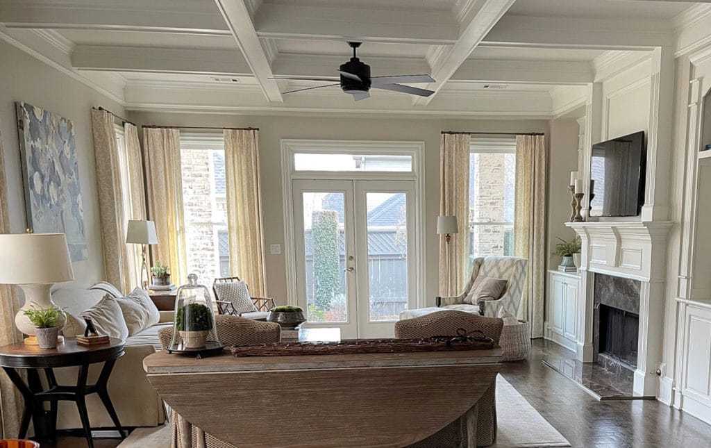 Living room with top beige paint color, Sherwin Williams Accessible Beige, wood floor, coffered ceilings. Kylie M Interiors Edesign, client photo