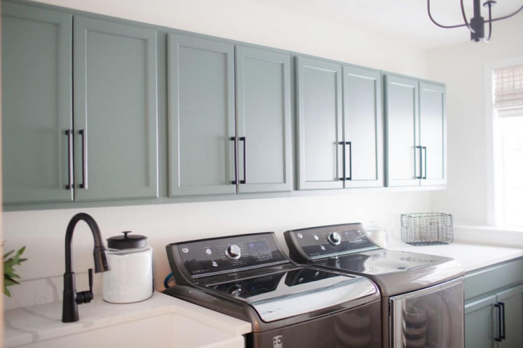Laundry room cabinets painted Benjamin Caldwell Green, White Dove walls, black aplliances, sink. Kylie M INteriors Edesign, client photo