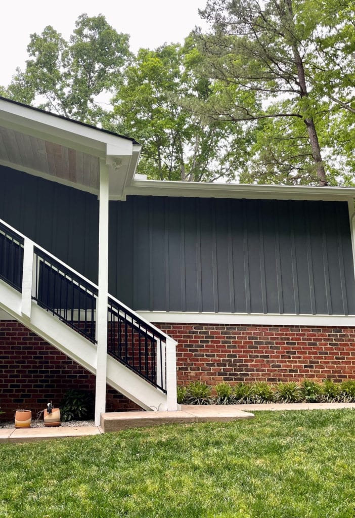 Exterior of home with James Hardie Iron Gray, red orange brick and Sherwin Williams Extra White trim. Kylie M.