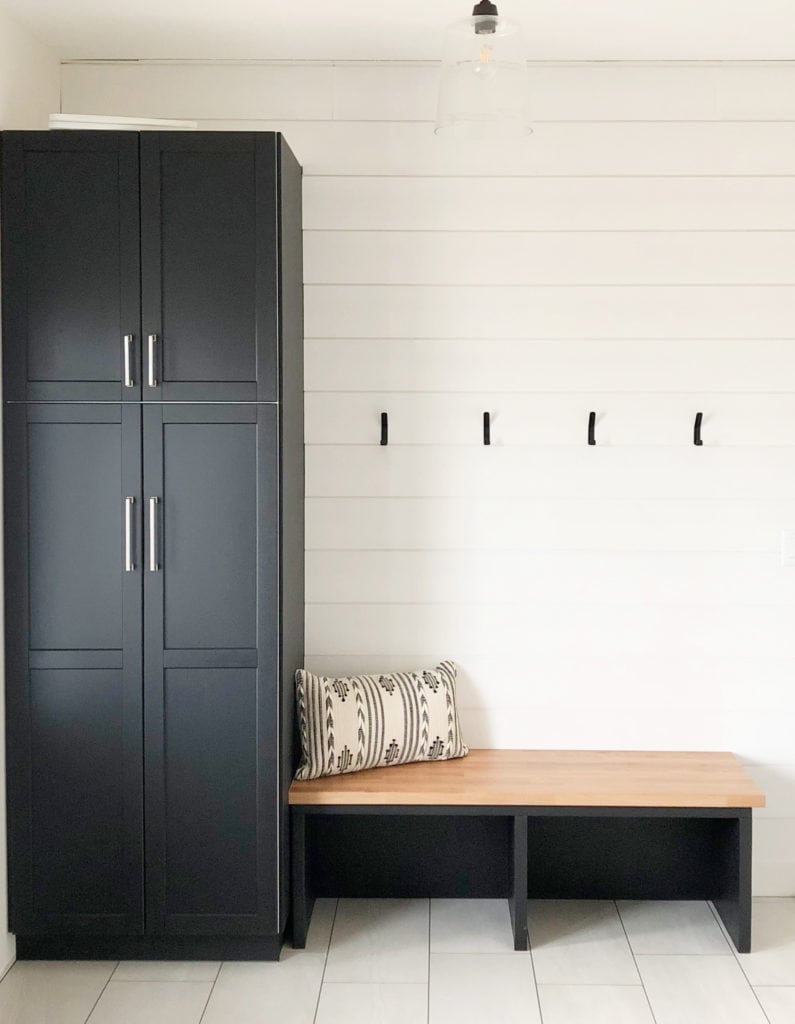 How to choose best white paint colour. Benjamin Moore Glacier White, black built-in bench entryway storage. Kylie M Interiors client photo