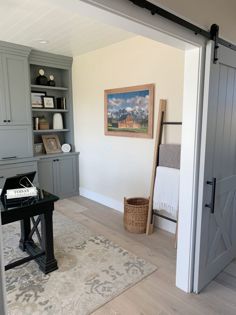 Magnolia Clunch paint color on home office built-ins, with whitewashed wood floor, off-white walls