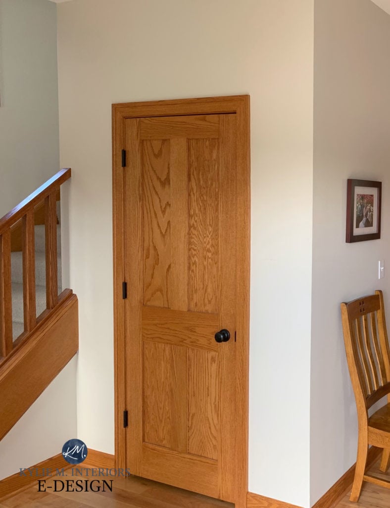 Orange toned wood door, wood trim and railing with popular warm neutral paint colour, Sherwin Williams Neutral Ground. Kylie M Interiors Edesign, online paint color