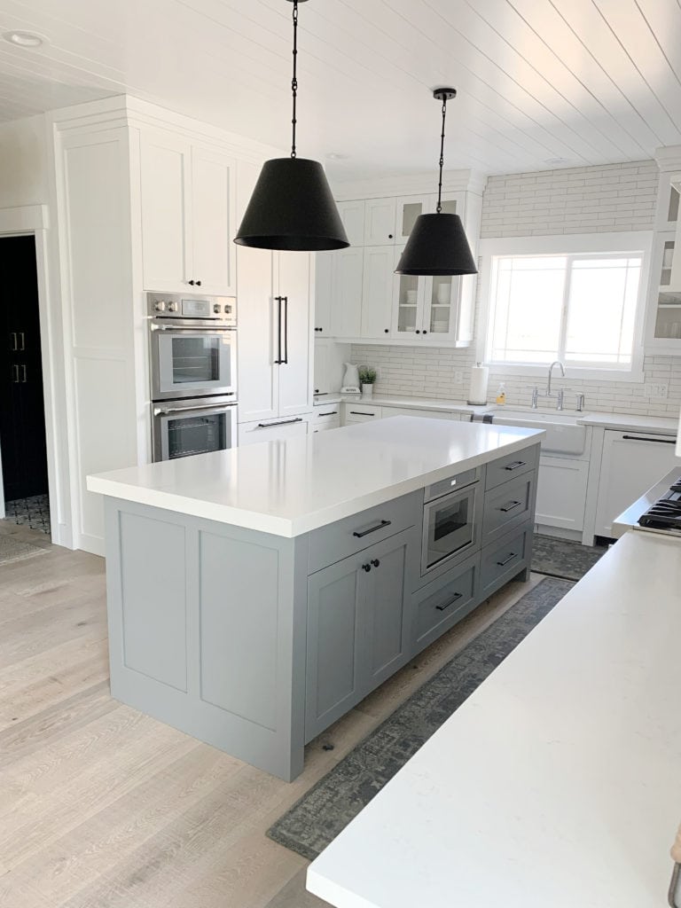 Sherwin Williams High Reflective White and Magnolia Teak Cups island, white quartz countertop, whitewash wood floor. CLIENT PHOTO of Kylie M Interiors Edesign