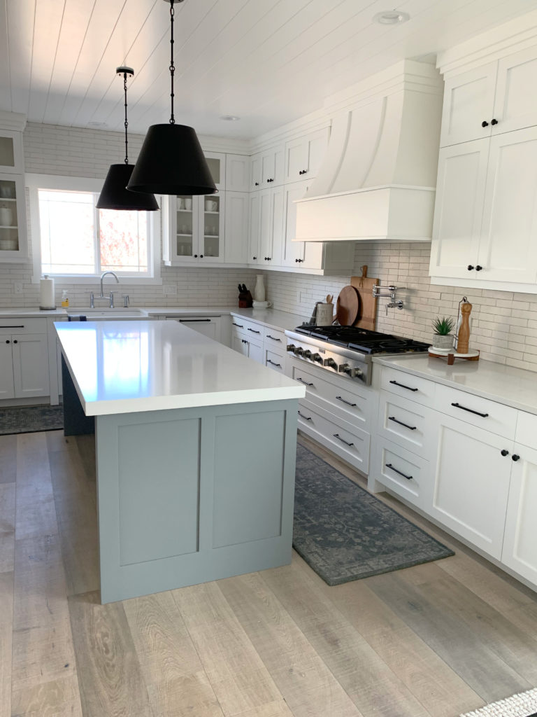 Magnolia Teak Cups, blue-green on kitchen island with Sherwin Williams High Reflective White on cabinets, white subway tile, gray grout