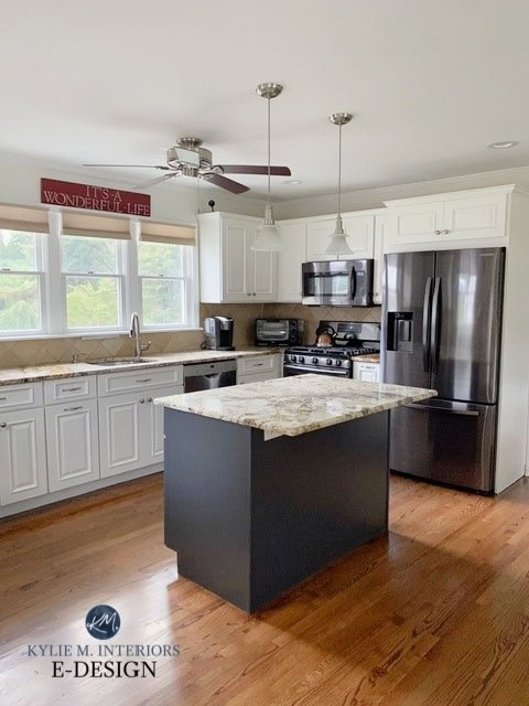 Cherry, maple wood cabinets. Painted a warm soft white by Benjamin Moore. travertine look backsplash. Older granite countertops. Red oak floor. Kylie M Interiors Edesign, diy update ideas (1)