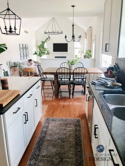 Sherwin Williams Alabaster, best warm white paint colour. Open layout kitchen, living room, dining, kitchen, dark black granite countertop. Kylie M Int
