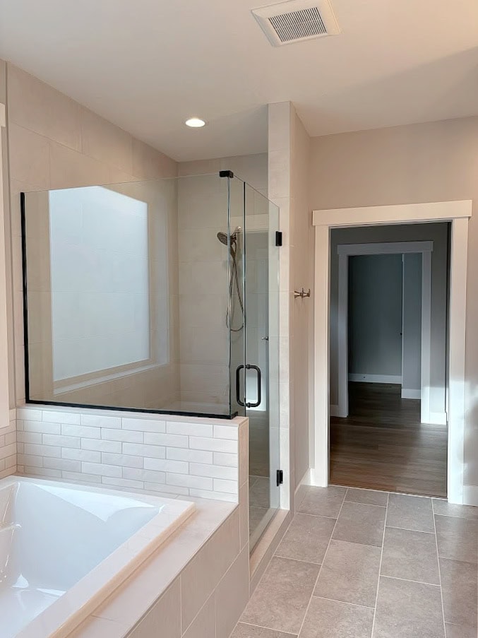 BATHROOM WITH SOAKER TUB, WALK IN SHOWER, SHERWIN WILLIAMS AGREEABLE GRAY WALL PAINT, PURE WHITE, WARM GRAY, GREIGE TAUPE TILE FLOOR