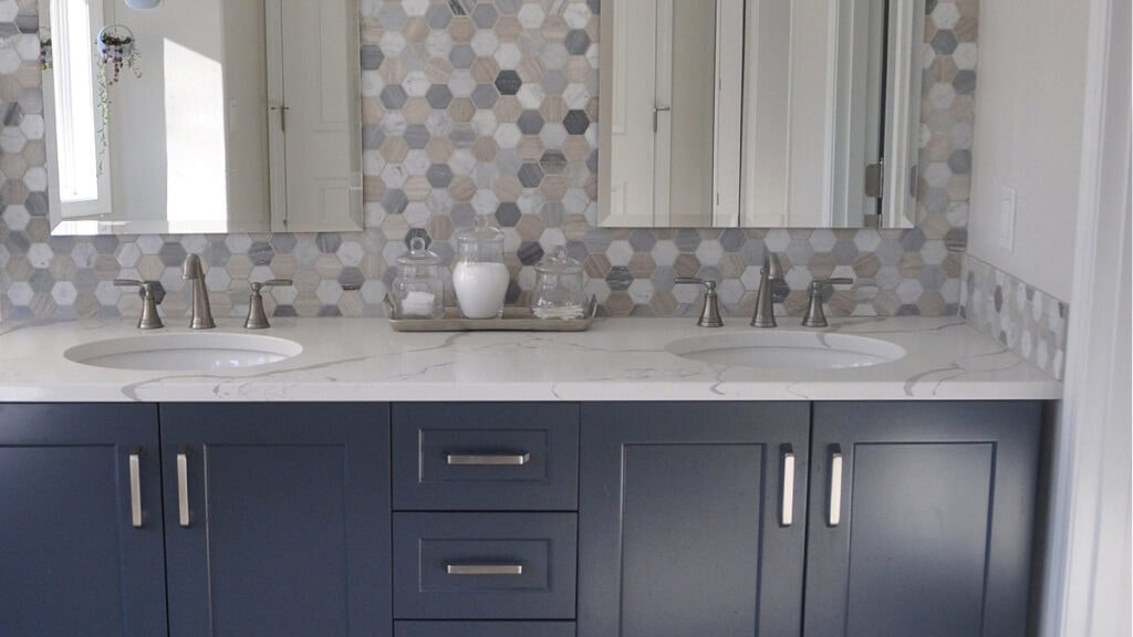 Benjamin Moore Hale Navy looking blue vanity in bathroom with hexagon marble backsplash and white quartz