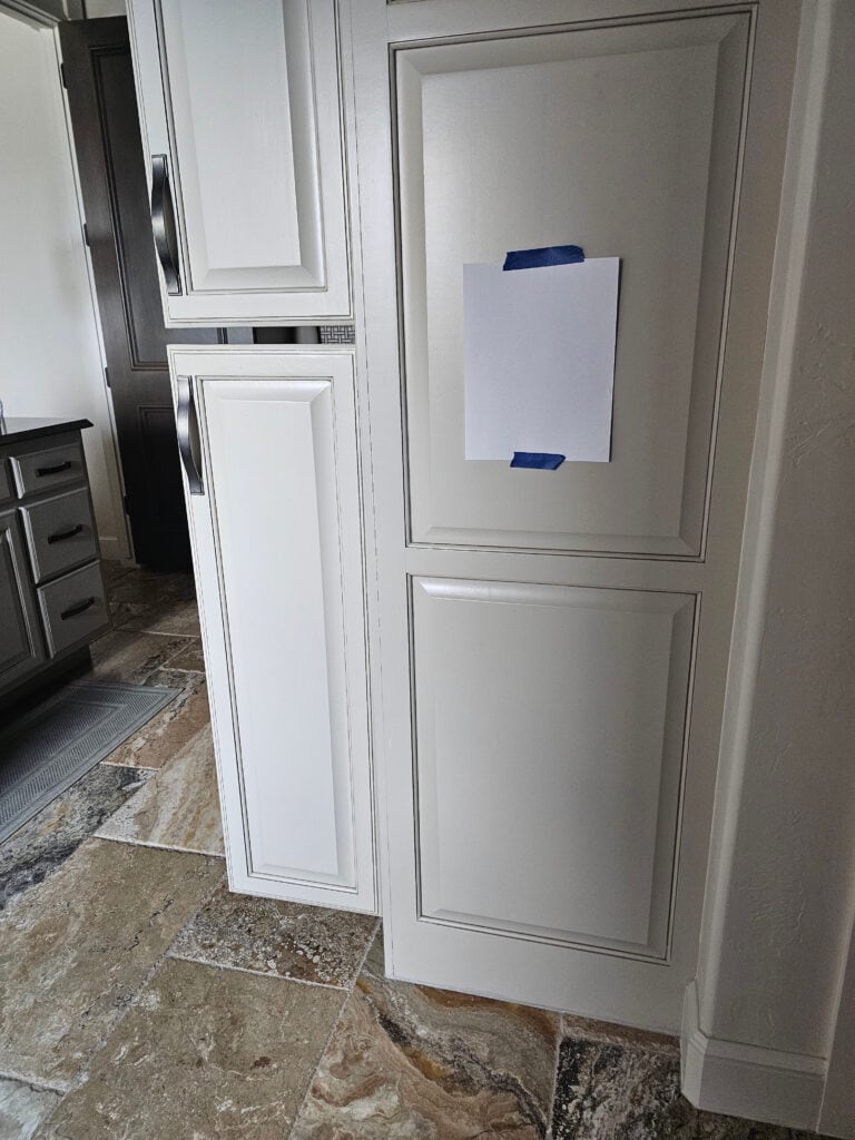 Benjamin Moore Revere Pewter cabinet with mild glaze, travertine tile floor in bathroom