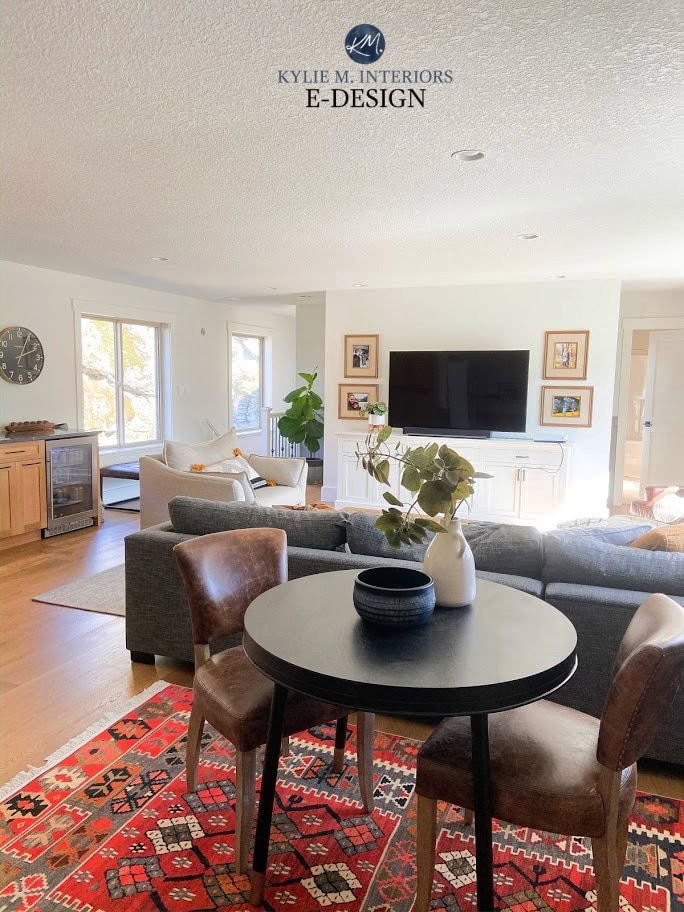 Benjamin Moore White Dove, bright living room or family room, gray sectional, tv above painted cabinets. Kylie M Interiors Edesign
