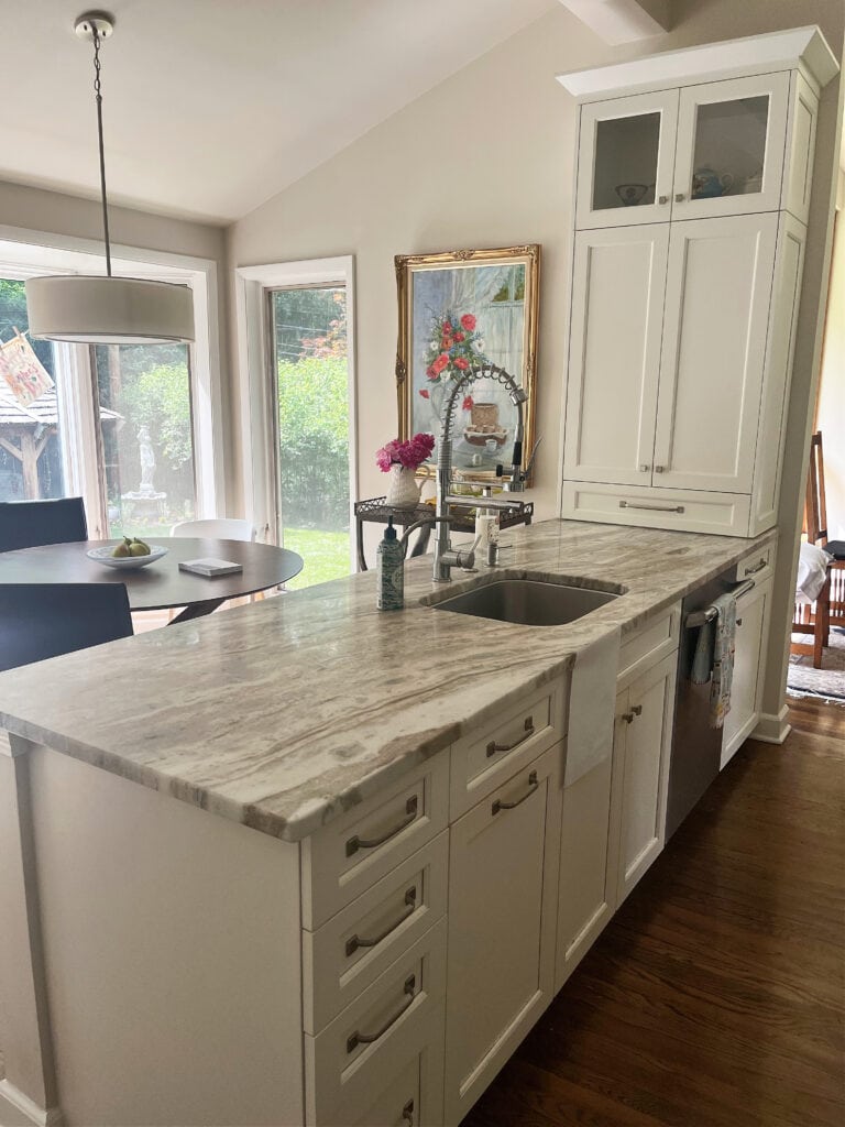 Cafe au lait quartzite countertop, honed, war mwhite cabinets, Benjamin Moore Winds Breath warm neutral on walls,
