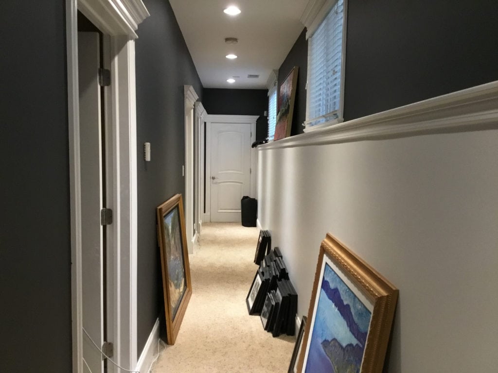 Dark hallway with chair rail, beige carpet, lower walls Benjamin Moore Oxford White upper walls Gray 2121-10. Kylie M Interiors Edesign, diy decorating ideas