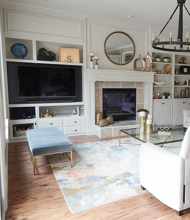 Fireplace surround and built ins painted off white Sherwin Williams Aesthetic, travertine tile suround, oak floor. Kylie M Interiors