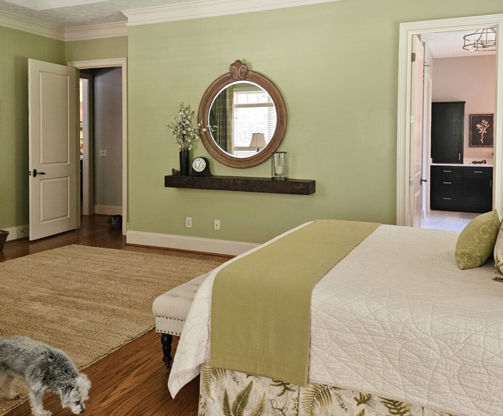 Green paint color on walls in primary bedroom with warm neutral linens, Moderne White trim